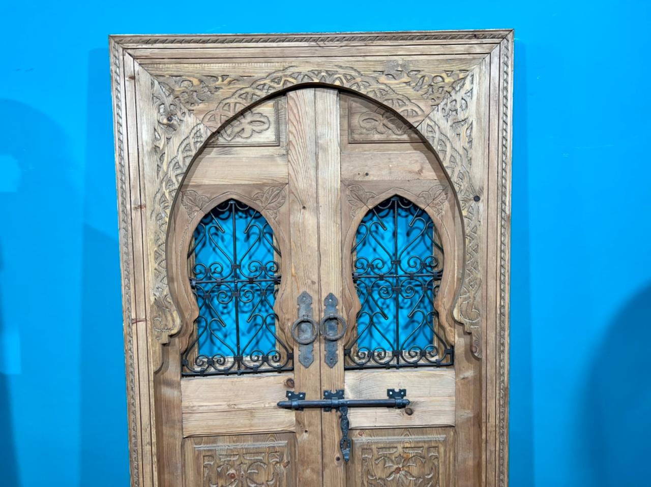 Traditional Moroccan door carved wooden door, with two windows in wrought iron worked a hand. wall decor.