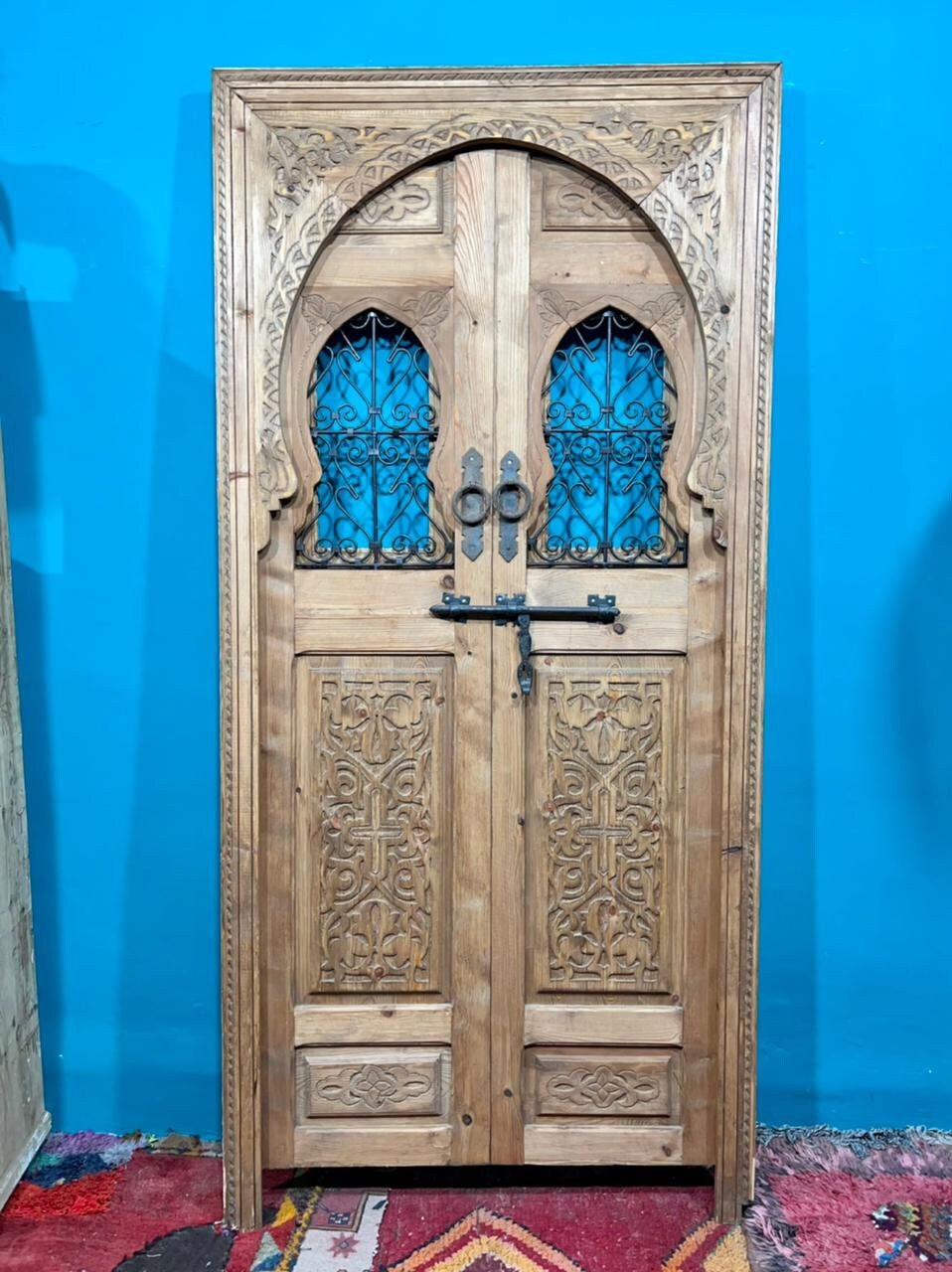 Traditional Moroccan door carved wooden door, with two windows in wrought iron worked a hand. wall decor.