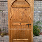 Moroccan-inspired wooden door with geometric carvings
