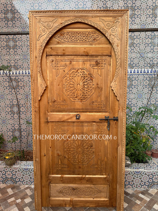 Moroccan-inspired wooden door with geometric carvings