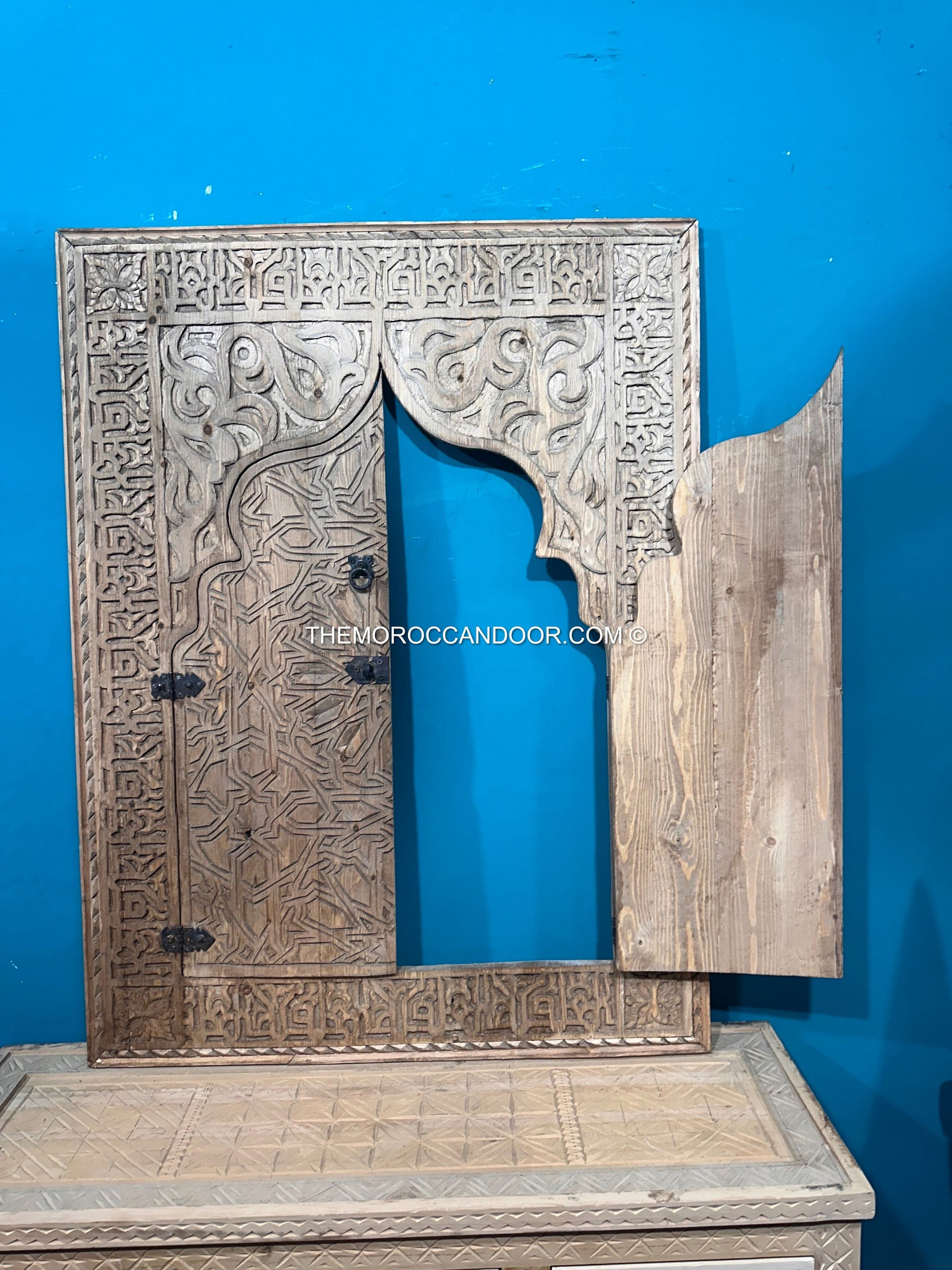 Hand-carved wooden Moroccan vintage window with a brass lock and handle, ready to ship in a beautiful brown wood frame for your wall.